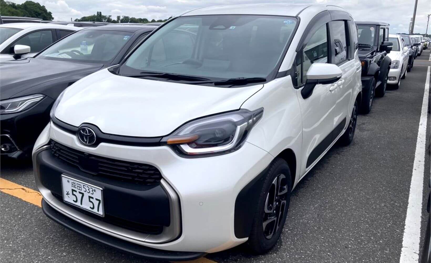 A White Toyota Sienna, at a Japanese car auction.
