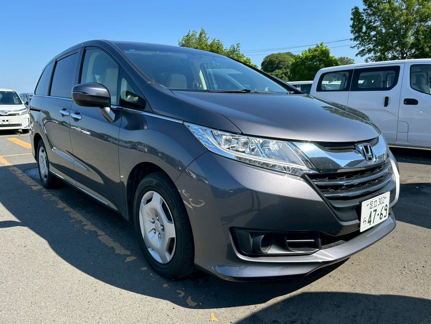 A grey Honda Odyssey family van a a Japanese used car auction