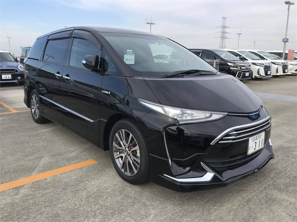 A black Toyota Estima family van at a Japanese used car auction