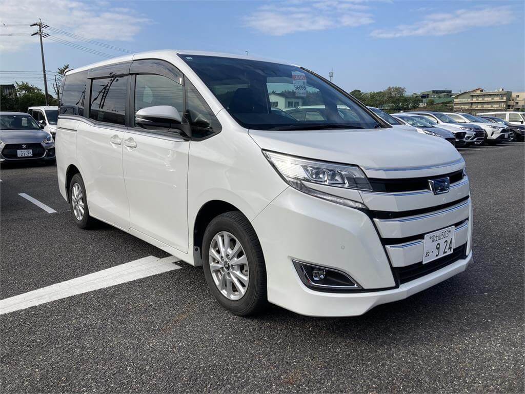 A white Toyota Noah family van at a Japanese used car auction