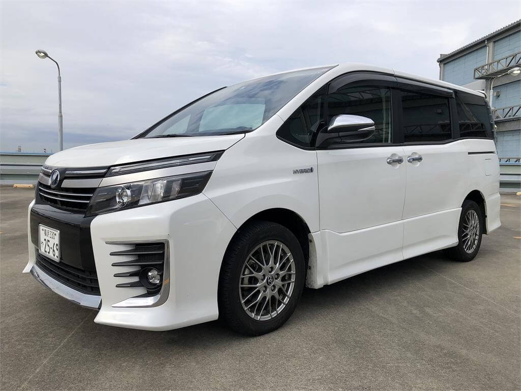 A white Toyota Voxy family van at a Japanese used car auction