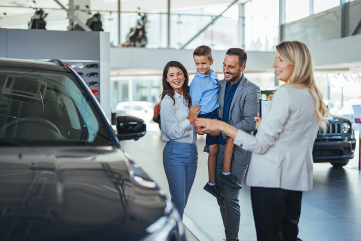 Happy family shopping for imported hybrid cars 